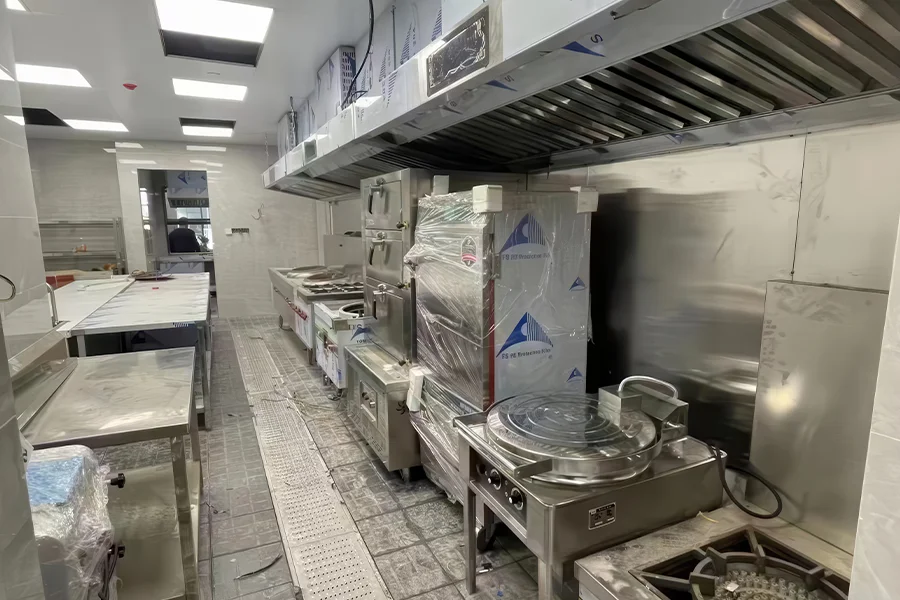 Various types of commercial kitchen equipment including ranges, ovens used in professional food preparation environments.