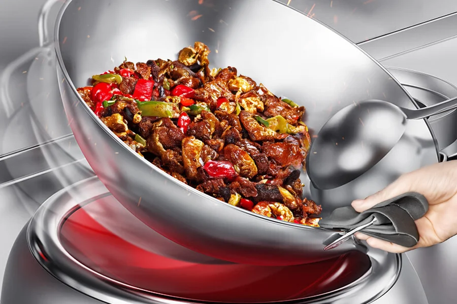 Stir-fry dish with beef, red and green bell peppers, and mushrooms in a induction wok range, being stirred with a ladle.