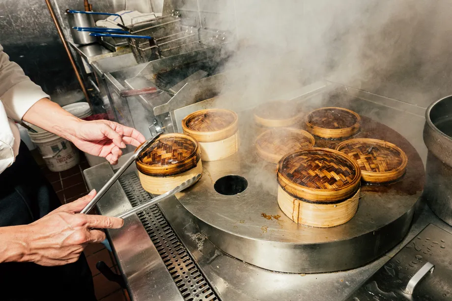 Large capacity commercial steamer filled with dumplings and buns for Yum Cha