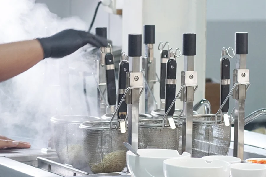 Commercial automatic lifting noodle cooker with multi-basket design in restaurant kitchen