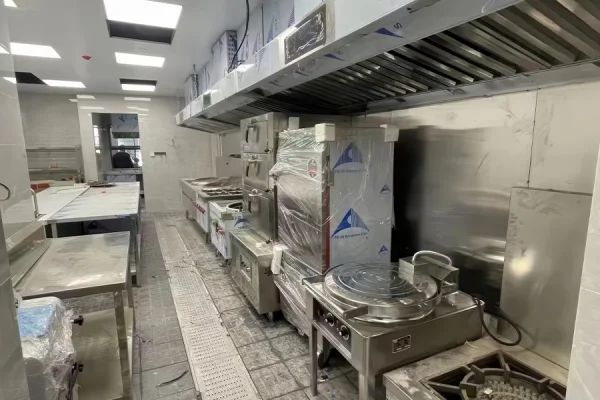 Various types of commercial kitchen equipment including ranges, ovens used in professional food preparation environments.