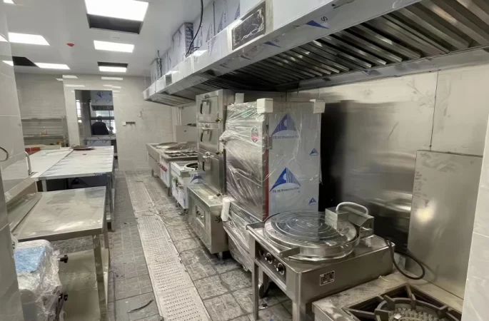 Various types of commercial kitchen equipment including ranges, ovens used in professional food preparation environments.